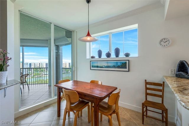 dining area with crown molding and light tile patterned floors