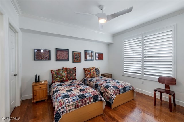 bedroom with dark hardwood / wood-style flooring, ceiling fan, and crown molding