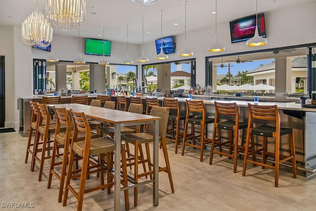 dining area featuring plenty of natural light, a high ceiling, and a chandelier