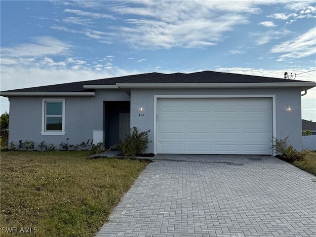 ranch-style house with a garage and a front yard