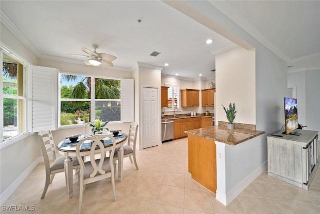 kitchen with kitchen peninsula, stainless steel dishwasher, light tile patterned floors, stone counters, and ceiling fan