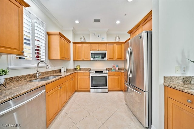 kitchen with light stone countertops, stainless steel appliances, light tile patterned floors, crown molding, and sink