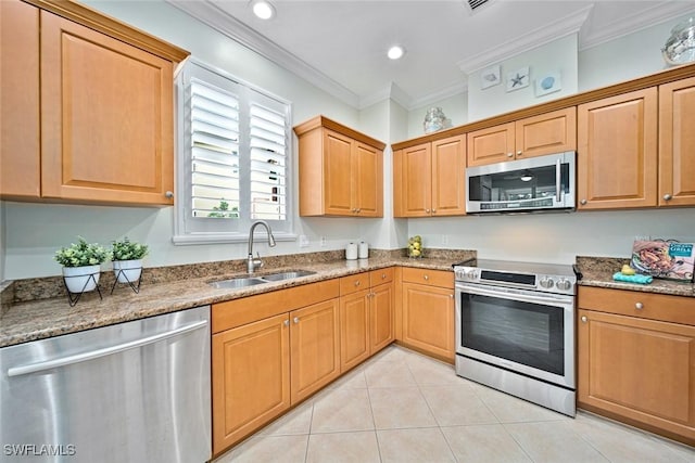 kitchen featuring stainless steel appliances, ornamental molding, dark stone countertops, and sink