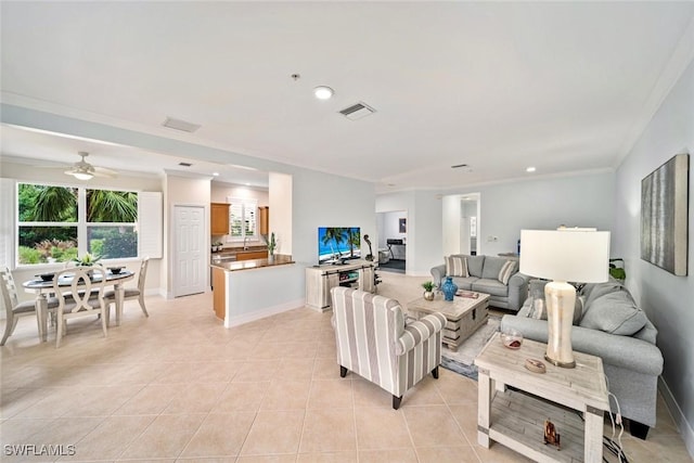 living room with ceiling fan, light tile patterned floors, and crown molding