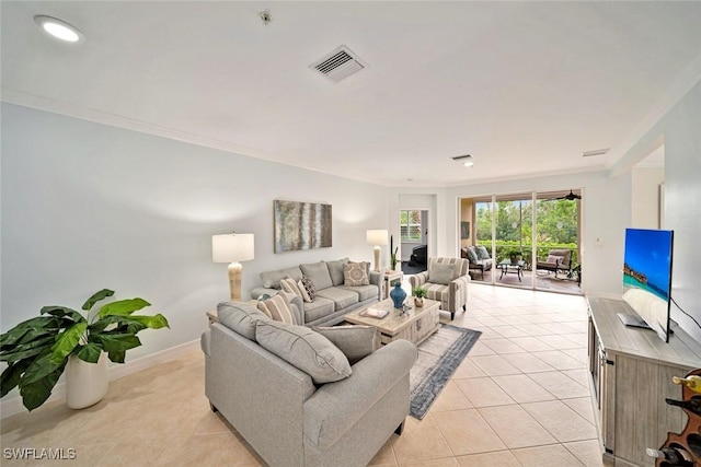 living room featuring crown molding and light tile patterned flooring