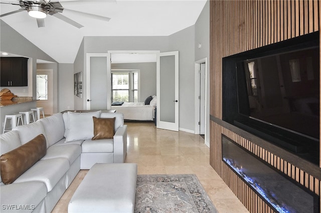 living room with ceiling fan, french doors, and vaulted ceiling