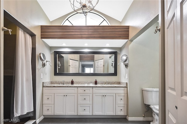 bathroom with lofted ceiling, vanity, and toilet