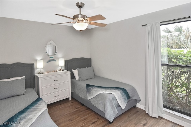 bedroom with ceiling fan and dark wood-type flooring