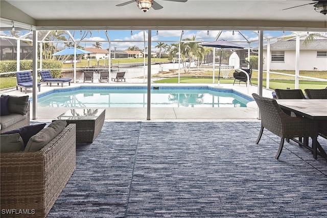 view of swimming pool with an outdoor hangout area, ceiling fan, glass enclosure, and a patio