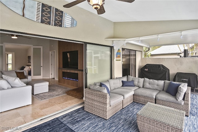 interior space featuring ceiling fan, an outdoor living space, and area for grilling