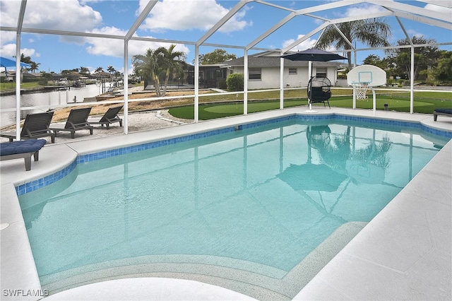 view of swimming pool featuring a lanai, a yard, a water view, and a patio