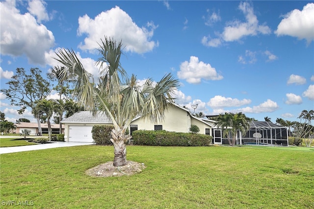 view of front of home featuring a garage, a lanai, and a front lawn