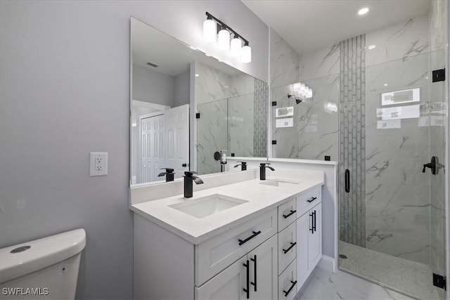 bathroom with toilet, walk in shower, and vanity