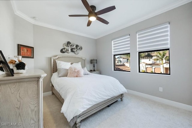 bedroom featuring crown molding, light colored carpet, and ceiling fan