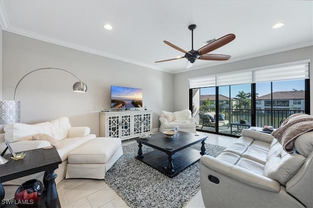 living room with ceiling fan and ornamental molding