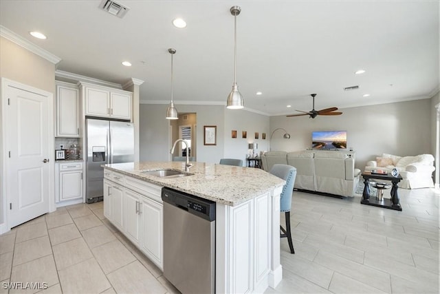 kitchen featuring white cabinetry, appliances with stainless steel finishes, sink, and a center island with sink