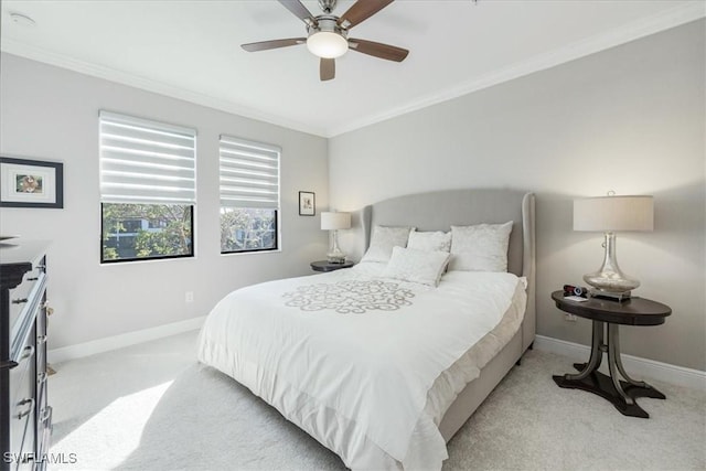 carpeted bedroom with ceiling fan and ornamental molding