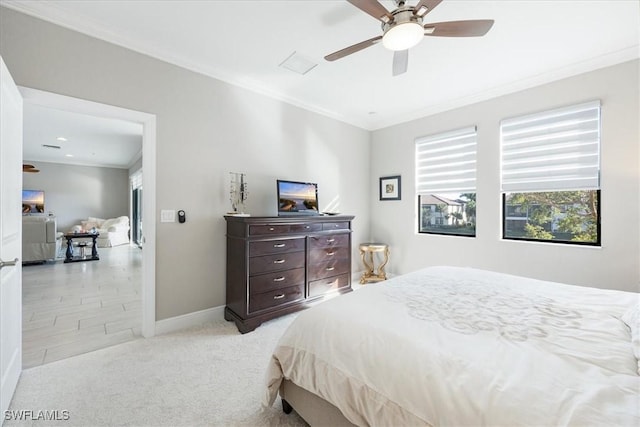 bedroom featuring crown molding, light colored carpet, and ceiling fan