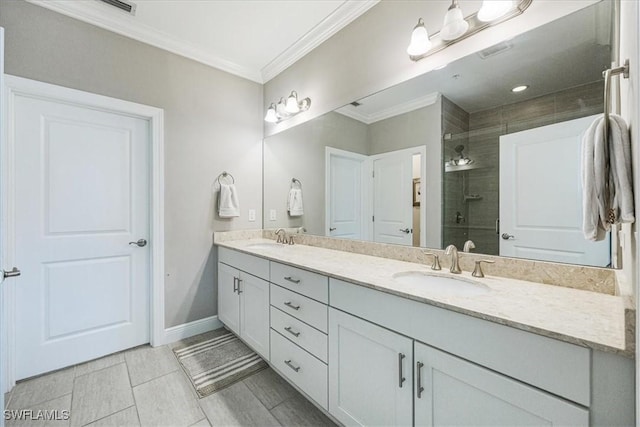 bathroom with ornamental molding, a shower with shower door, and vanity