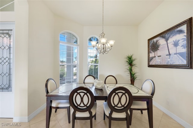 tiled dining room featuring a chandelier