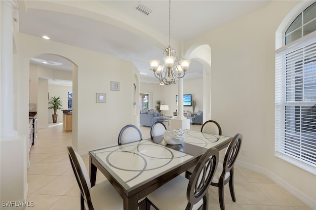 dining space with an inviting chandelier and light tile patterned floors