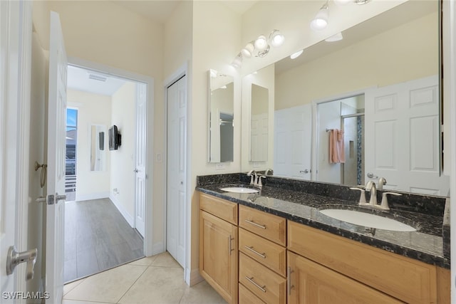 bathroom featuring vanity, tile patterned floors, and a shower with shower door