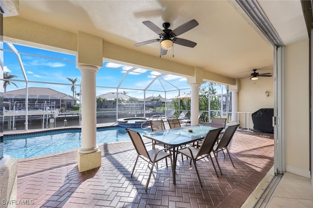 view of patio with a swimming pool with hot tub, a grill, ceiling fan, and glass enclosure