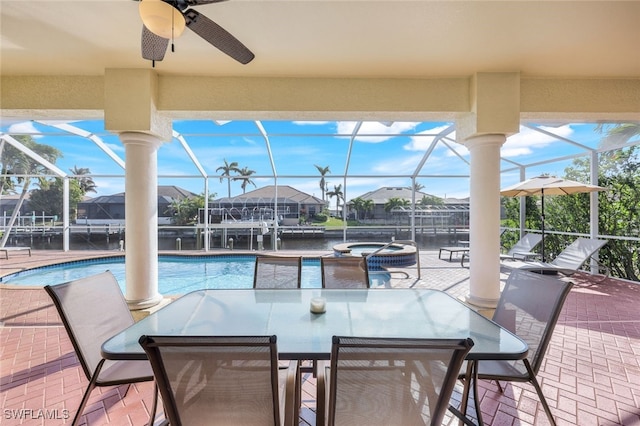 view of patio / terrace with a water view, a lanai, and a pool with hot tub