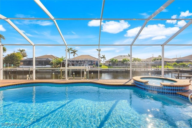 view of swimming pool with a water view, glass enclosure, and an in ground hot tub