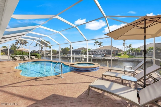 view of swimming pool featuring a lanai, a patio area, an in ground hot tub, and a water view