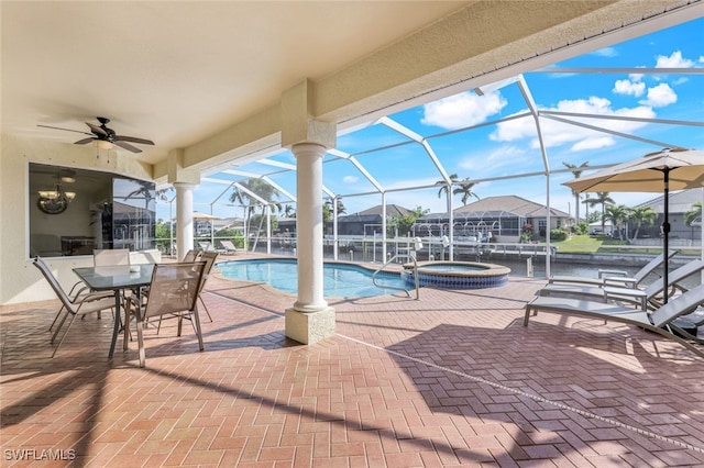 view of pool featuring a lanai, a patio area, and an in ground hot tub