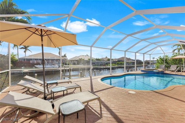 view of pool featuring a water view, an in ground hot tub, a patio area, and glass enclosure