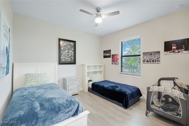 bedroom featuring light hardwood / wood-style flooring and ceiling fan