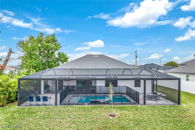 rear view of property featuring a lanai, a patio area, and a yard