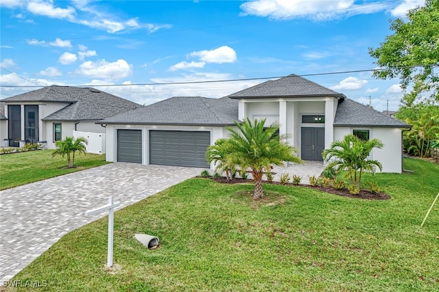 view of front of home featuring a front yard and a garage