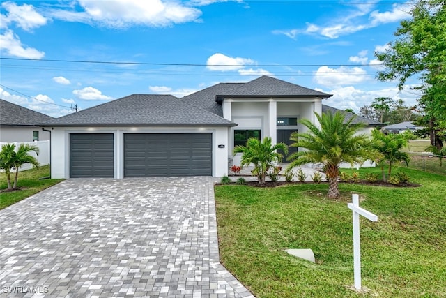 view of front of home with a front yard and a garage