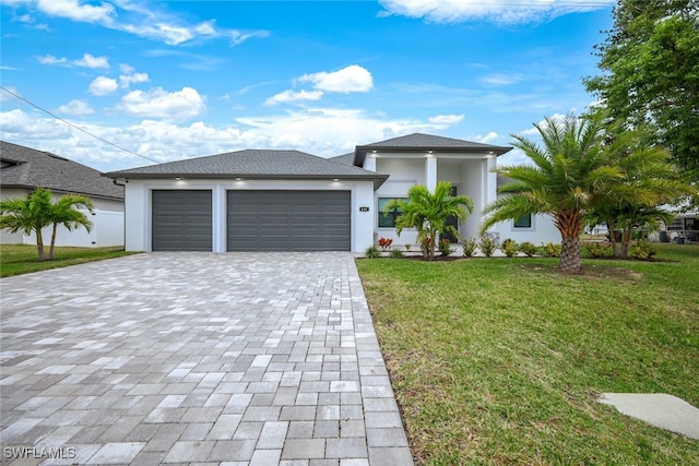 view of front of home featuring a garage and a front lawn