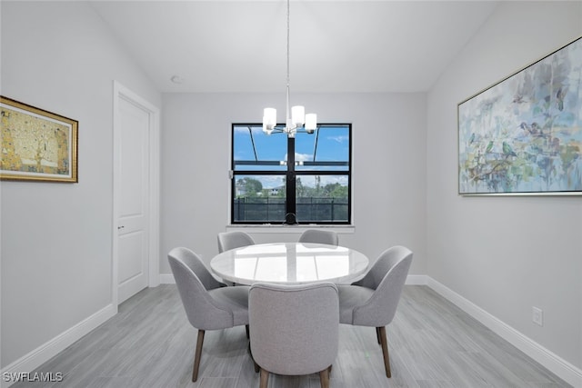 dining space with a chandelier and light hardwood / wood-style flooring