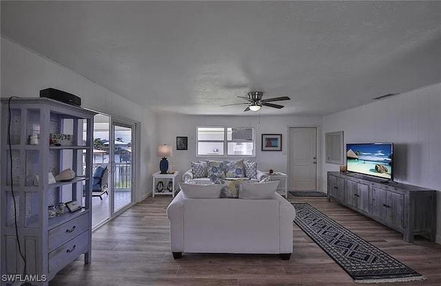 living room featuring hardwood / wood-style flooring and ceiling fan