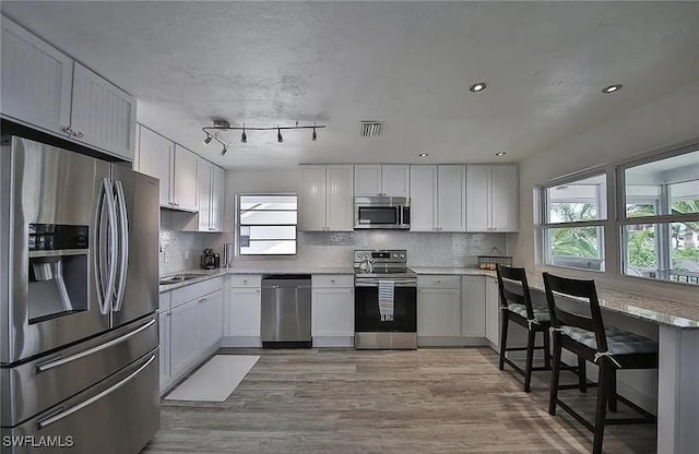 kitchen with white cabinetry and stainless steel appliances