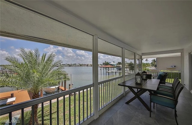 sunroom / solarium with a water view and a wealth of natural light