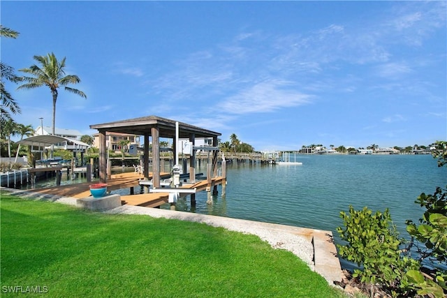 dock area featuring a lawn and a water view