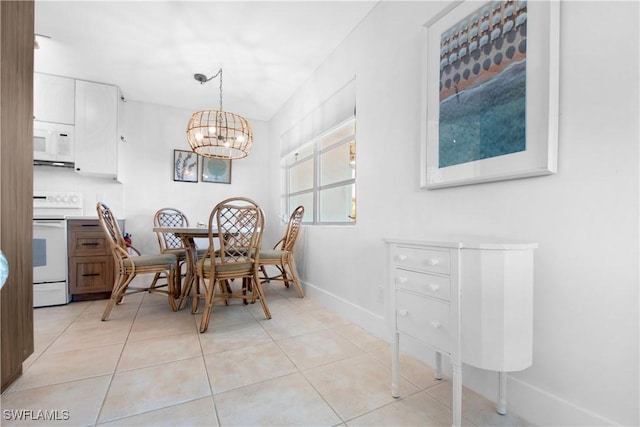 dining area with light tile patterned flooring and an inviting chandelier