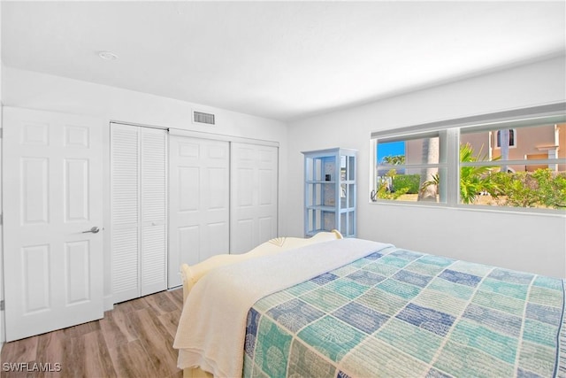 bedroom with light hardwood / wood-style flooring and a closet