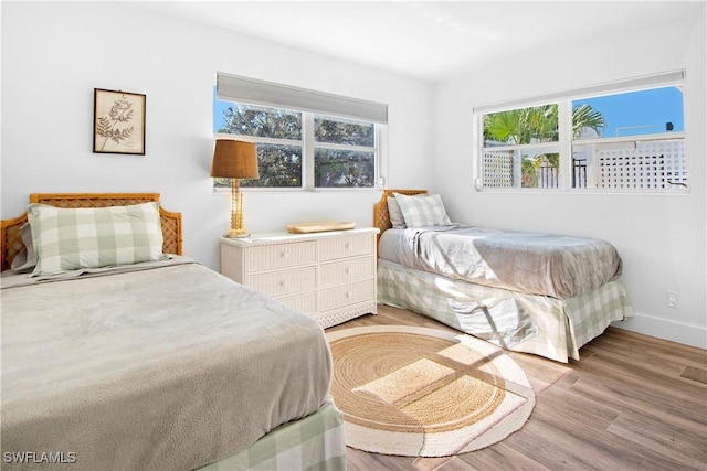 bedroom featuring light wood-type flooring and multiple windows