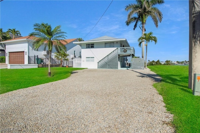 view of front of house featuring a front lawn and a garage