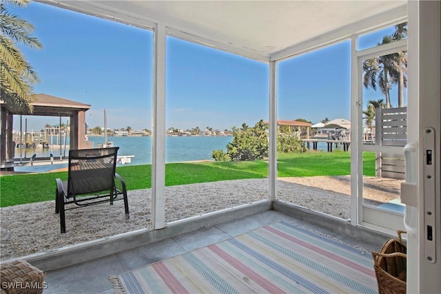 sunroom with plenty of natural light and a water view