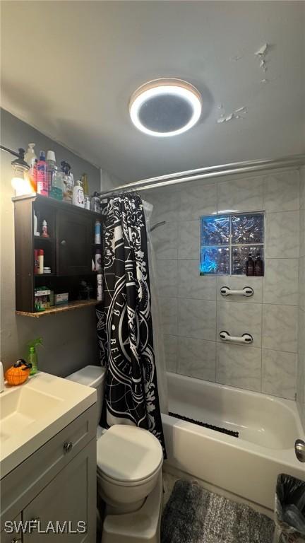 full bathroom featuring toilet, vanity, and shower / tub combo with curtain