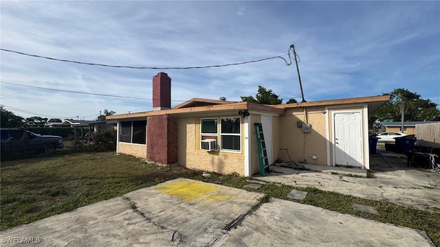 back of property featuring a patio and a yard