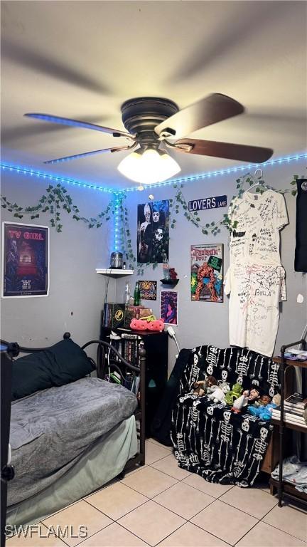 tiled bedroom featuring a ceiling fan